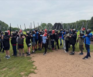 The whole class are enjoying an activity together this morning…boys against girls archery tag!!